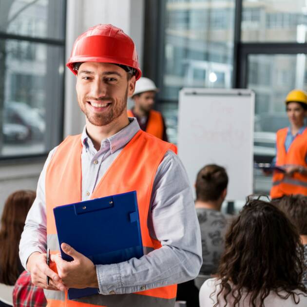 cheerful fireman holding clipboard near coworkers giving talk on briefing